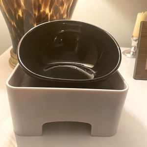 Elevated and adjustable dog bowl with side-opening, esp. good for smushed noses.